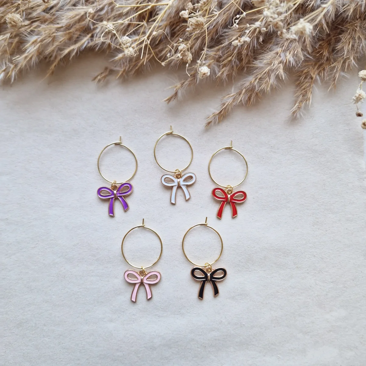 Strikje wijnglasringen goud